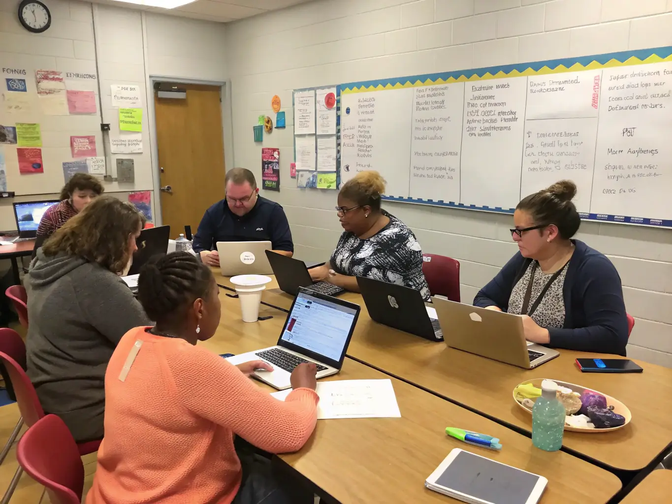 A photo of parents and teachers collaborating during a parent-teacher meeting, emphasizing the importance of community involvement and support.
